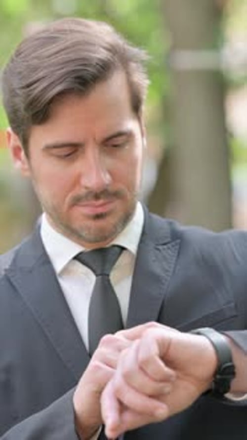 Man in Suit Checking Watch Outdoor