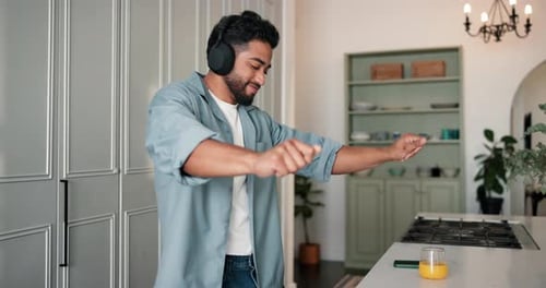Man Dancing at Home Wearing Headphones
