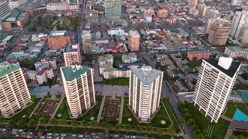 Aerial dolly in of Viña del Mar luxury apartments and neighborhood buildings in blue hour, Chile