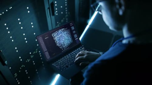 Data Center IT Engineer Holds Laptop and Works on the Neural Network AI Project.