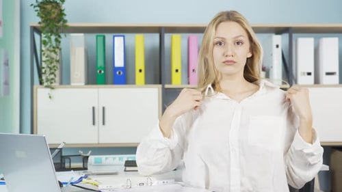 Young Woman Checking Appearance in Office Setting