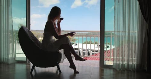 Woman Relaxes in Chair with Ocean View
