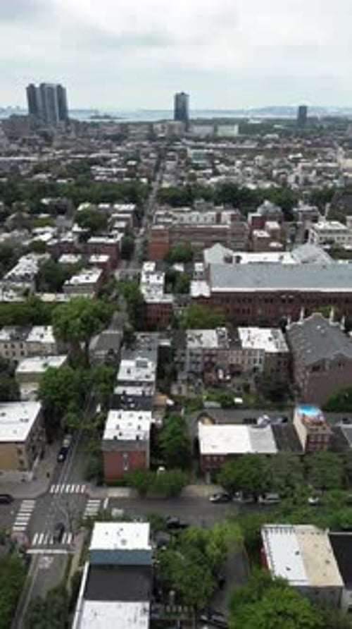 High-angle top-down view of a park in Jersey City featuring symmetrical paths, green spaces, and