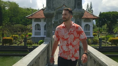 Young Confident Man Walking on the Bridge Bearded Handsome Guy is Traveling