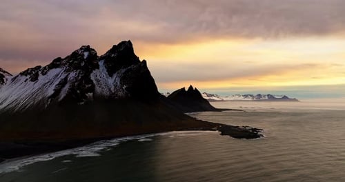 Gentle Sea Waves And Snow-Covered Vestrahorn At Sunset