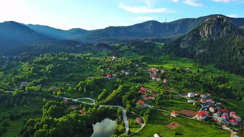 View From Rock to Town of Smolyan with Meadows for Cattle Walking and Houses Between Mountain Range