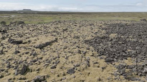 Flying Over Rocky Volcanic Terrain In Iceland On A Sunny Day. low aerial