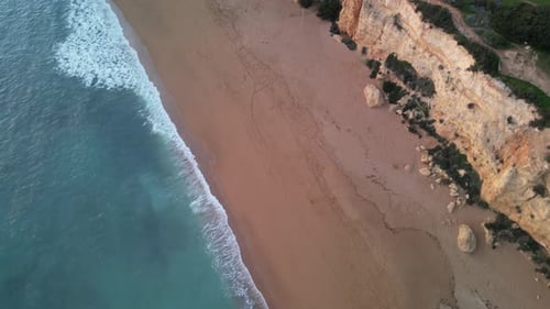 Aerial view of beach and cliffs by blue ocean, Portugal.