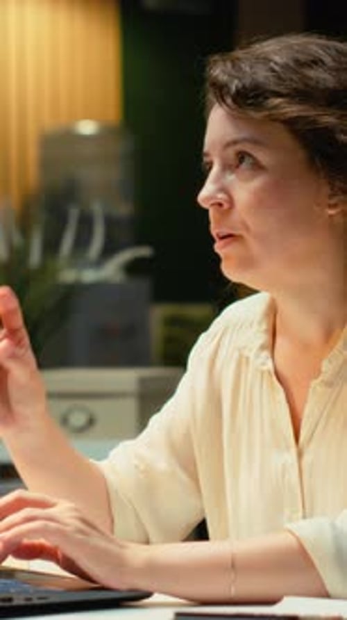Woman Working at Computer in Office Environment