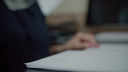 Pressing Stamp on Document at Office Desk