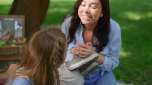 Family Pampering on Beautiful Meadow on Picnic Closeup. Pretty Parents Playing With