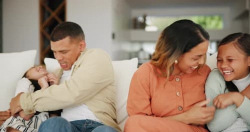 Loving Family Laughing and Embracing on Couch
