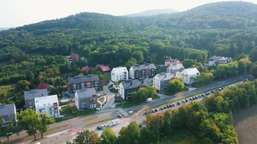 Modern Residential Houses Surrounded By Forest and Mountains Aerial View