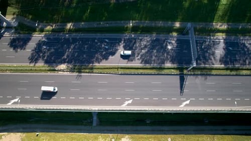 Aerial View Of Cars Driving In The Highway On A Sunny Day.