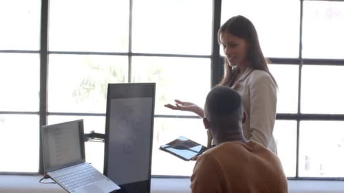 Colleagues Discussing Business Data in Modern Office