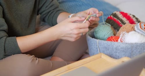 Woman Crocheting Yarn Indoors At Home