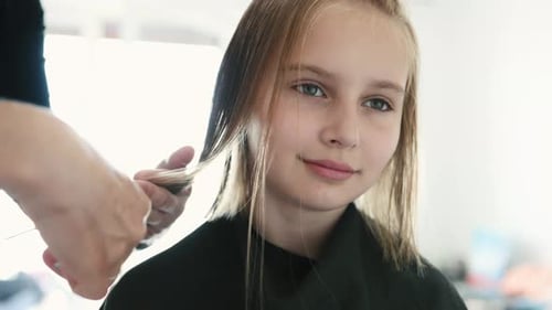Child Getting Haircut in Bright Indoor Setting