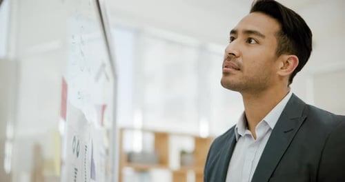 Thinking, smile and writing on glass with a businessman in his office for problem solving