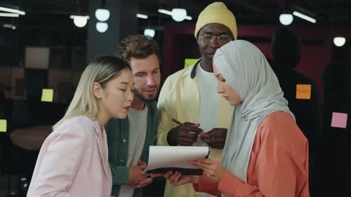 Multiethnic Business Team Discussing While Standing in the Office