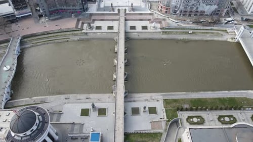 Historical bridges were built on the Vardar River in a cityscape with cultural buildings