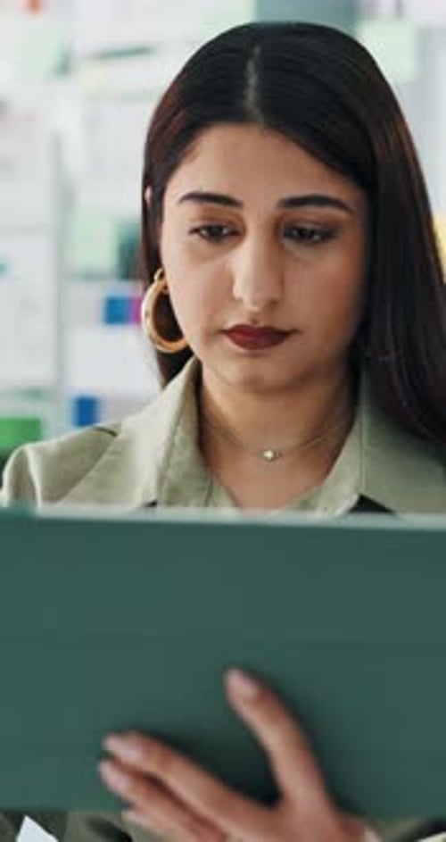 Creative, woman and reading with tablet in office for research, proofreading article and fact check