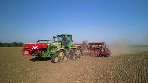Tractor on the field seeding wheat