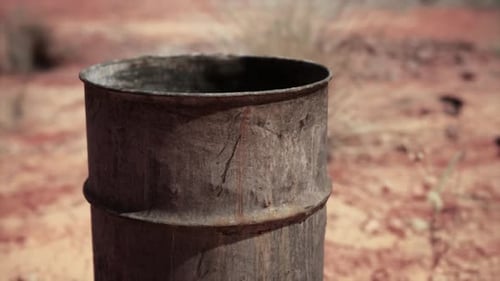 Old Empty Rusted Barrel on Sand