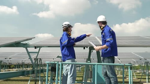 Engineers are working at solar farm.