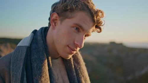 Man with Curly Hair in Warm Sunlight Outdoors