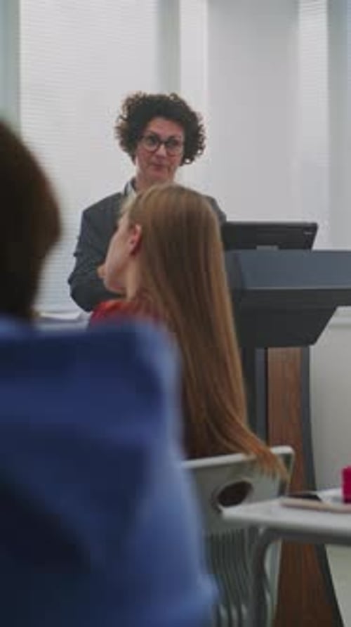 Teacher Giving Lesson to Students in Classroom