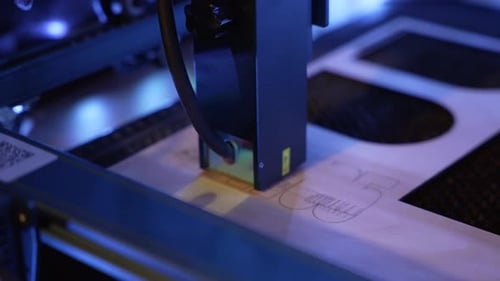 Close-Up Laser Engraver Cutting Wood Material Under Blue Industrial Lighting For Precision Craft