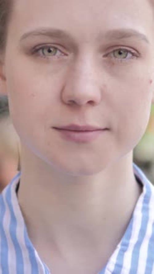 Outdoor Close Up of Serious Young Woman, Vertical Video