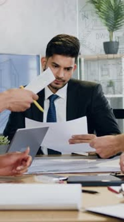 Goodlooking Purposeful Experienced Multiethnic Male and Female Engineers Transmitting Documents to