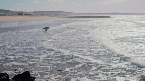 Aerial View of Man Carrying Surfing Board and Go Into Ocean for Surfing
