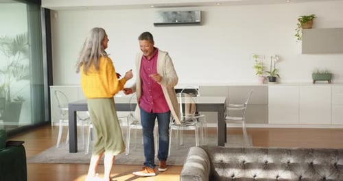 Happy Couple Dancing Together in Bright Home