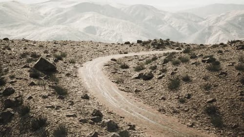Scenic Winding Road Through the Pamir Mountains in Tajikistan During Daylight