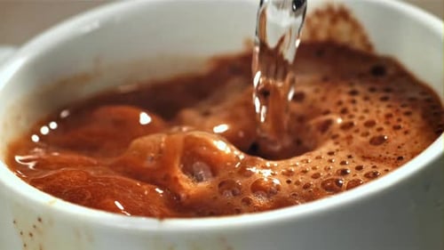 Water Being Poured into Coffee Close Up
