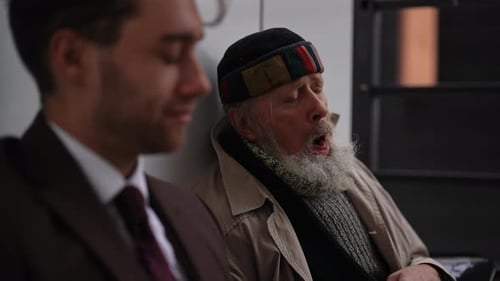 Older Bearded Man Sitting Next to Young Adult