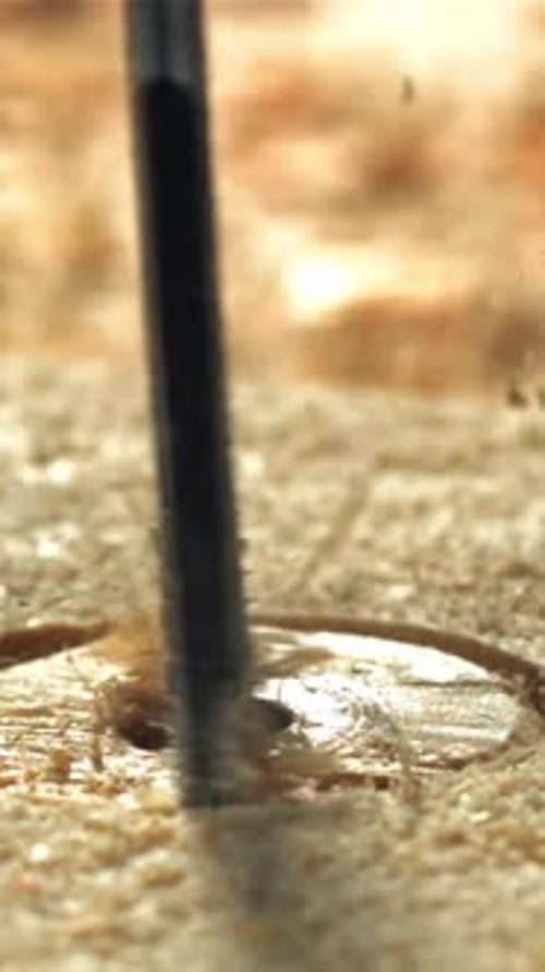 A Carpenter Drills a Hole in a Wooden Product Filmed on a Highspeed Camera at 1000 Fps