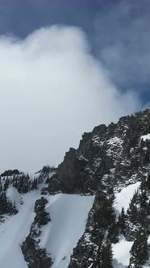 Snowy Mountain Peak. Blue sky and clouds. British Columbia, Canada.