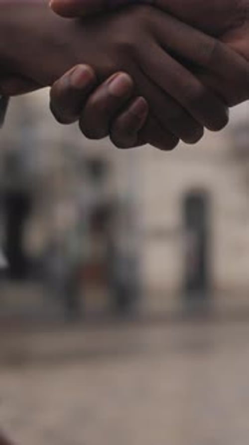 Close Up of Afro American Partners Shaking Hands Outdoors