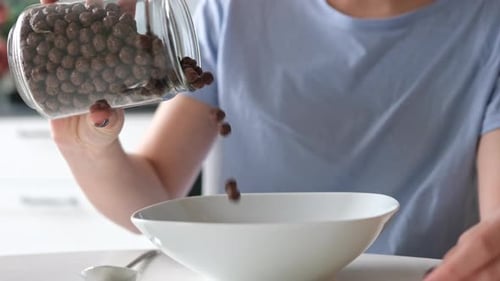Cereal Poured into a White Bowl for Breakfast