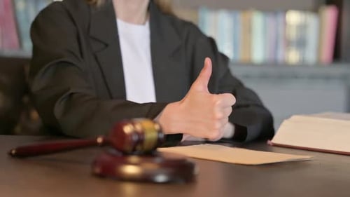 Close Up of Thumbs Up by Female Judge in Court, Scale of Justice