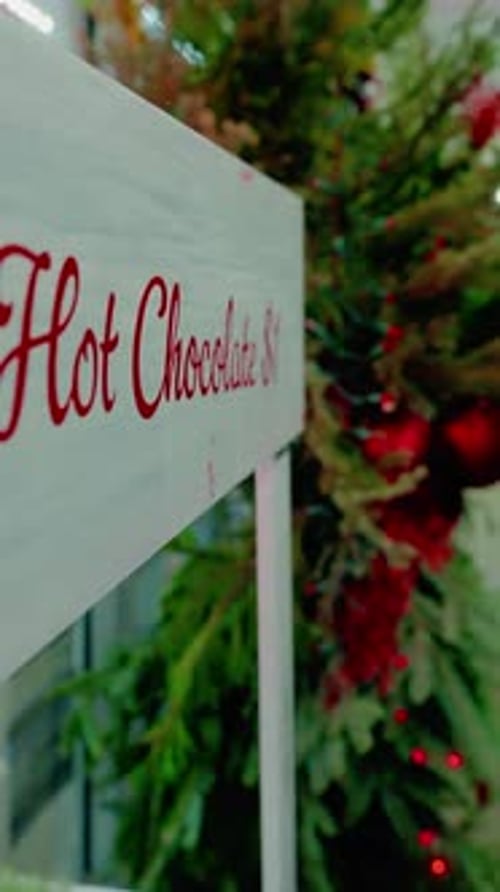 Close Up Pan of Hot Sign and Christmas Tree Outside Shop Vertical