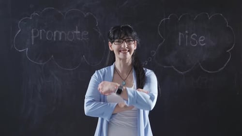 Woman Presenting in Front of a Chalkboard