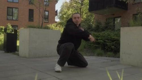 Street dancer performs dynamic breakdance moves, showcasing strength and agility