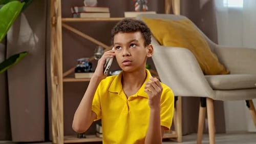 Boy Talking on Cellphone in Sunny Home