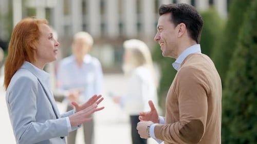 Business People Shaking Hands in the City Street