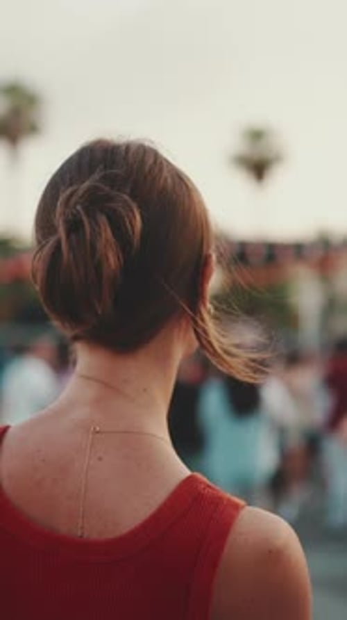 Close-up, girl stands on the square and looks around in downtown