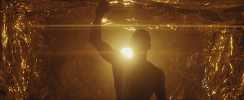 Silhouette with Gold Background and Arm Raised